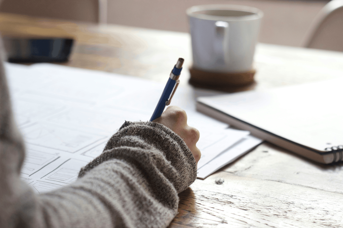 Person studying and working hard at a desk, focused on learning consistently